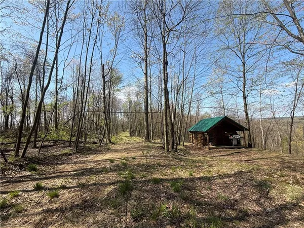 a view of a house with trees in the background
