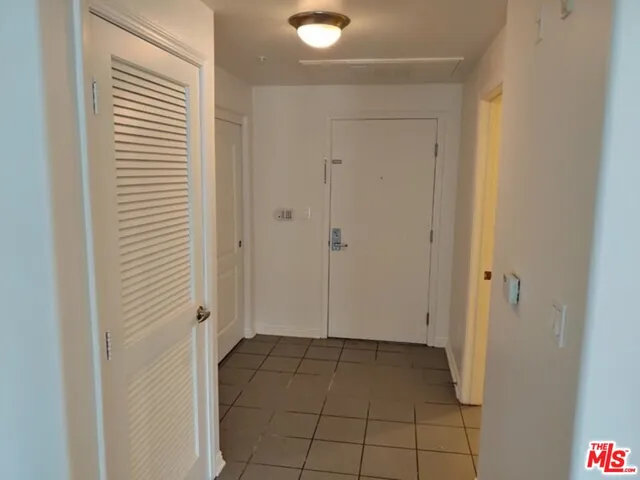 a kitchen with granite countertop a refrigerator stove and microwave