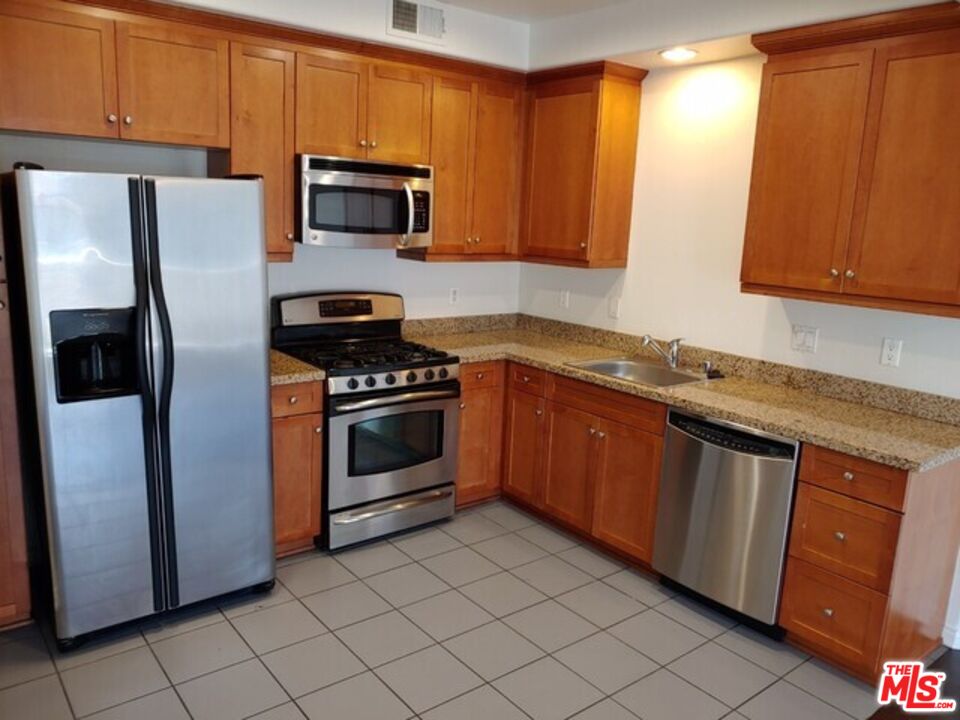 360 West Ave 26, Unit 339 Los Angeles, CA 90031 - Photo 4 of 10 a kitchen with granite countertop a refrigerator stove and microwave