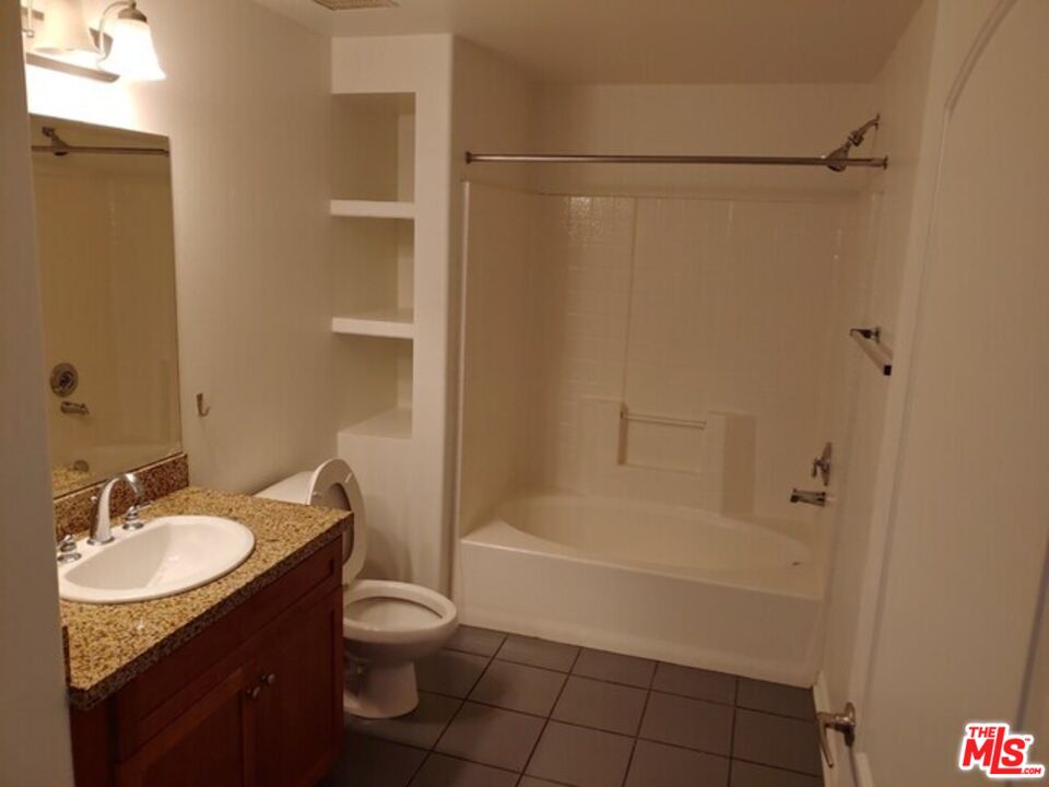 360 West Ave 26, Unit 339 Los Angeles, CA 90031 - Photo 5 of 10 a bathroom with a granite countertop sink toilet and shower