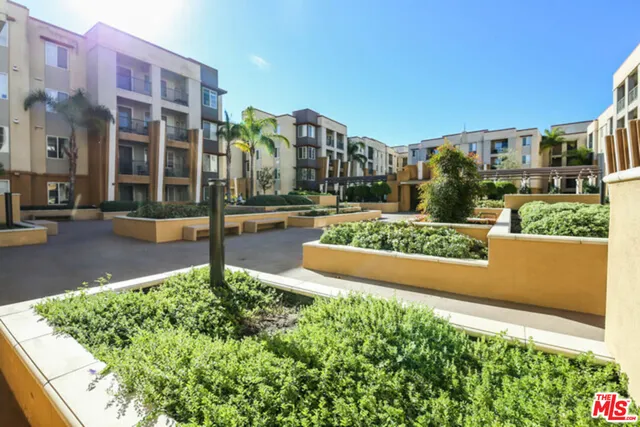 a bedroom with furniture and a large window