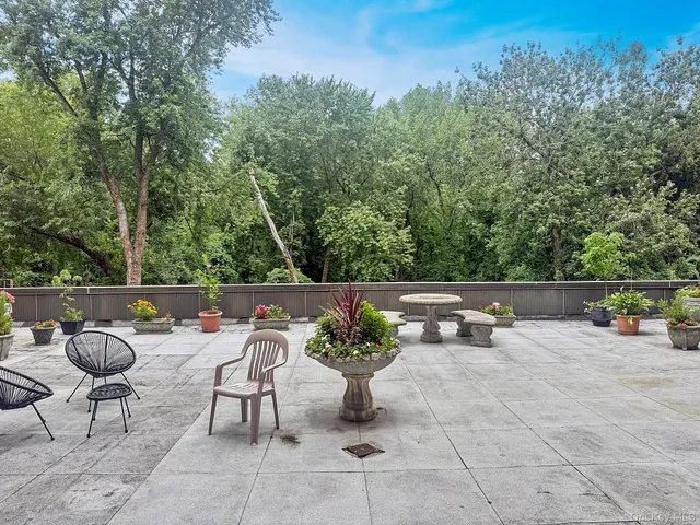 a terrace with outdoor seating and trees