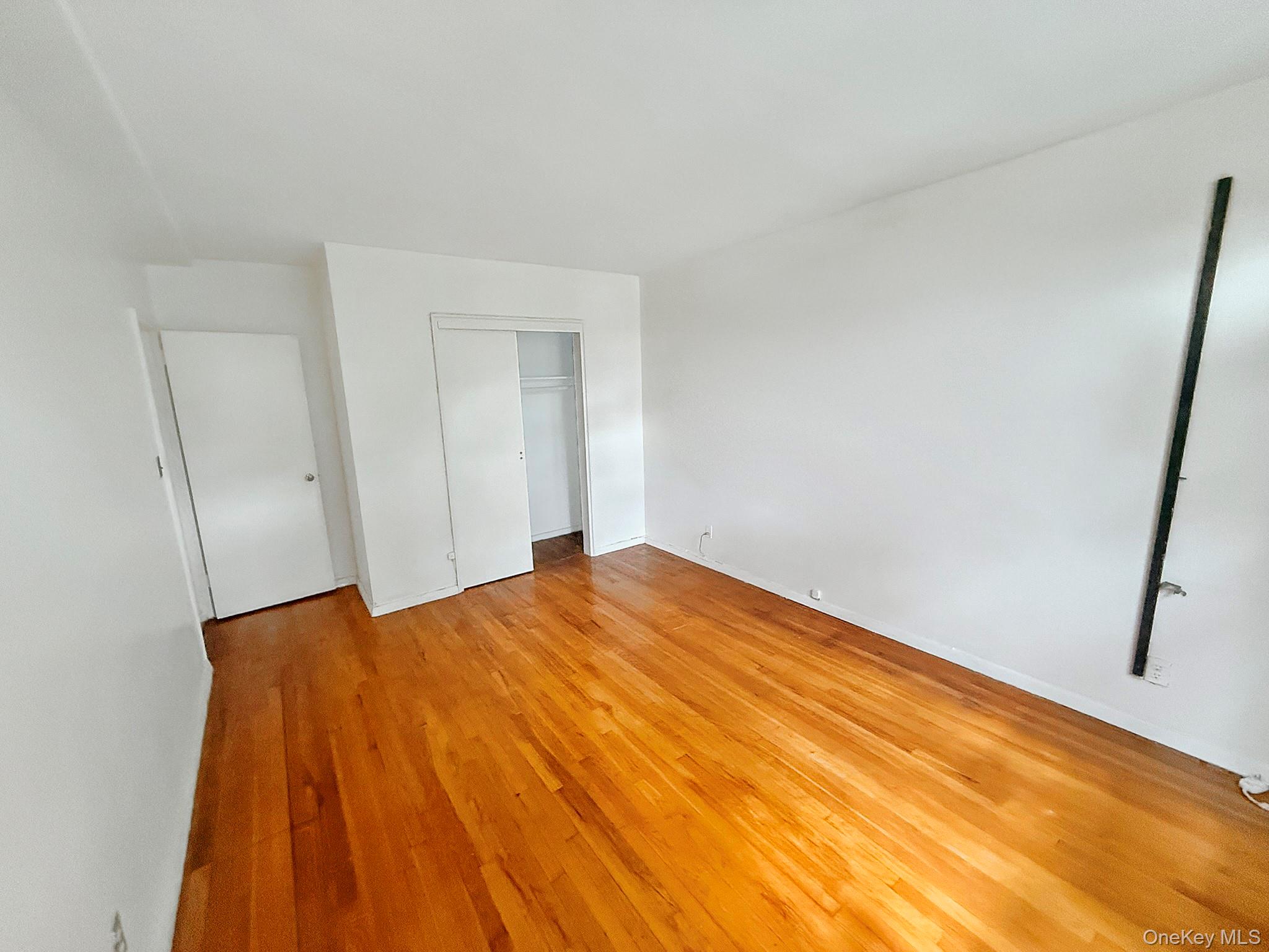 1111 Midland Avenue, Unit 5J Bronxville, NY 10708 - Photo 7 of 13 Unfurnished bedroom with light wood finished floors and a closet