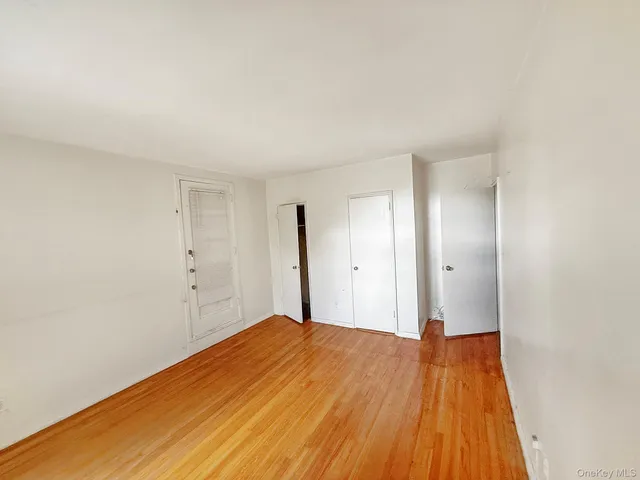 a big room with wooden floor and closet