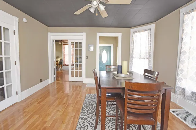 a view of a dining room with furniture window and wooden floor
