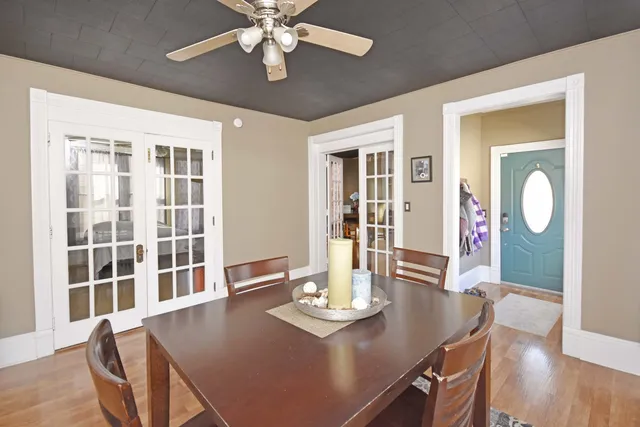 a view of a dining room with furniture wooden floor and chandelier