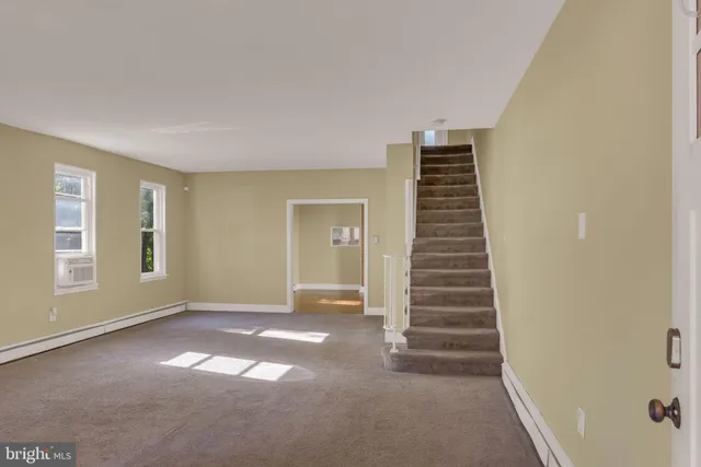 a view of an empty room with stairs