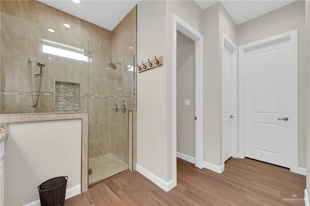 a bathroom with a granite countertop double vanity sink and mirror