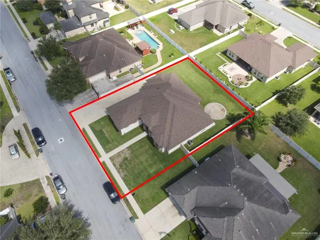 an aerial view of a tennis ground with a large pool