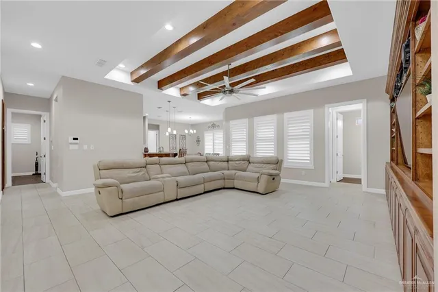 a living room with furniture and a chandelier