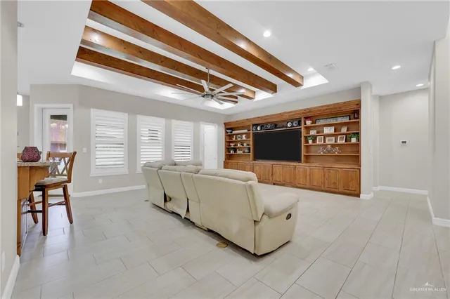 a living room with furniture and a ceiling fan