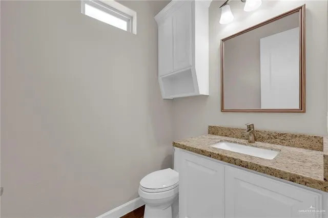 a kitchen with granite countertop cabinets stainless steel appliances a sink and a window