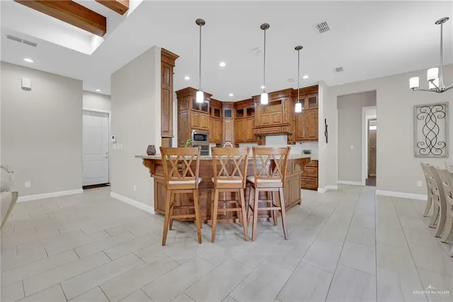 a bathroom with a granite countertop sink a toilet and a mirror