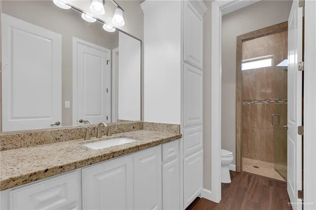 a bedroom with furniture and a wooden floor