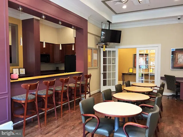 a view of a dining room with furniture wooden floor and chandelier