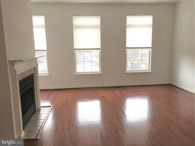 a view of a kitchen with a sink a fireplace and a window