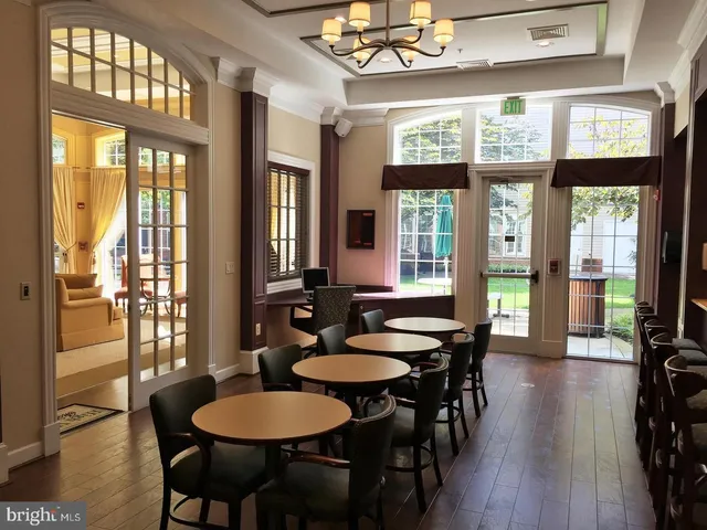 a living room with furniture and a book shelf