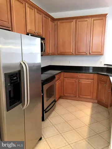 a kitchen with stainless steel appliances a stove a microwave and sink