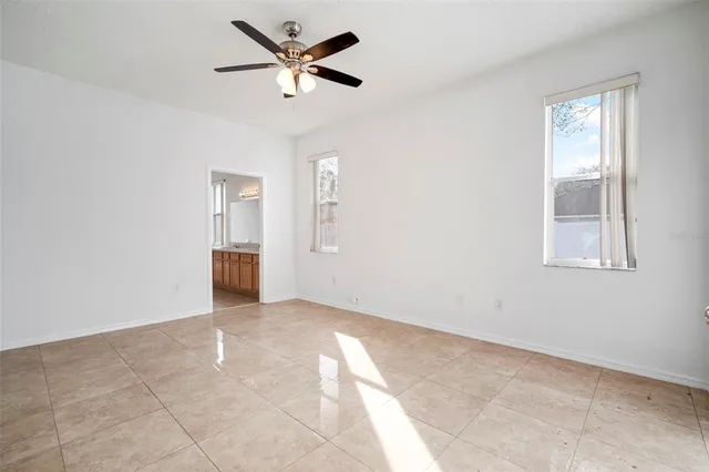 a view of a livingroom with a ceiling fan and window