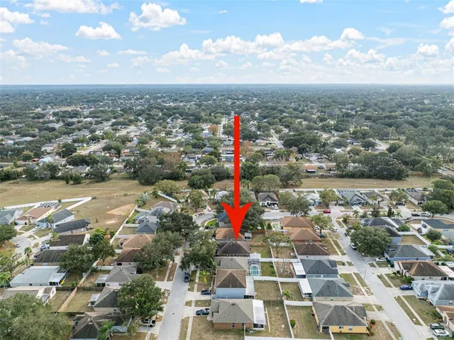 an aerial view of residential building with green space
