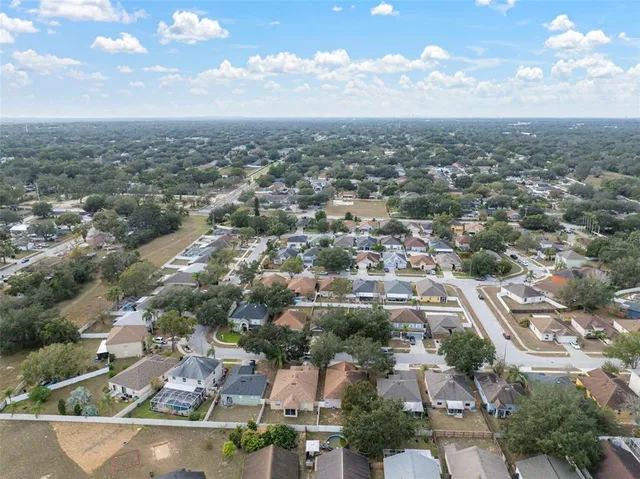 an aerial view of residential building with green space