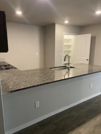 a bathroom with a granite countertop sink and a mirror