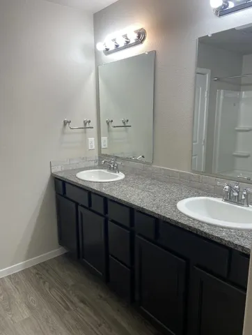 a bathroom with a granite countertop sink a large mirror and a