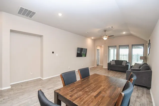 a kitchen with stainless steel appliances granite countertop a sink and a stove top oven with wooden floor