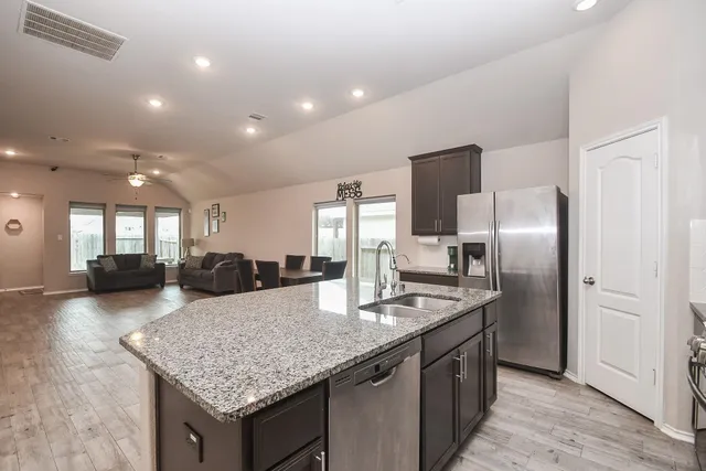 a kitchen with center island a sink and a large window