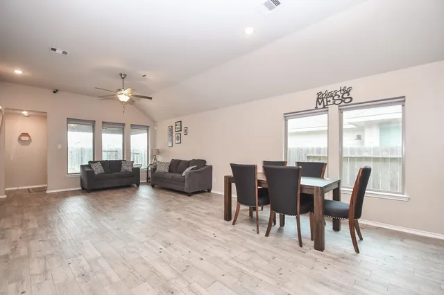 a view of kitchen with dining table chairs cabinets and stainless steel appliances