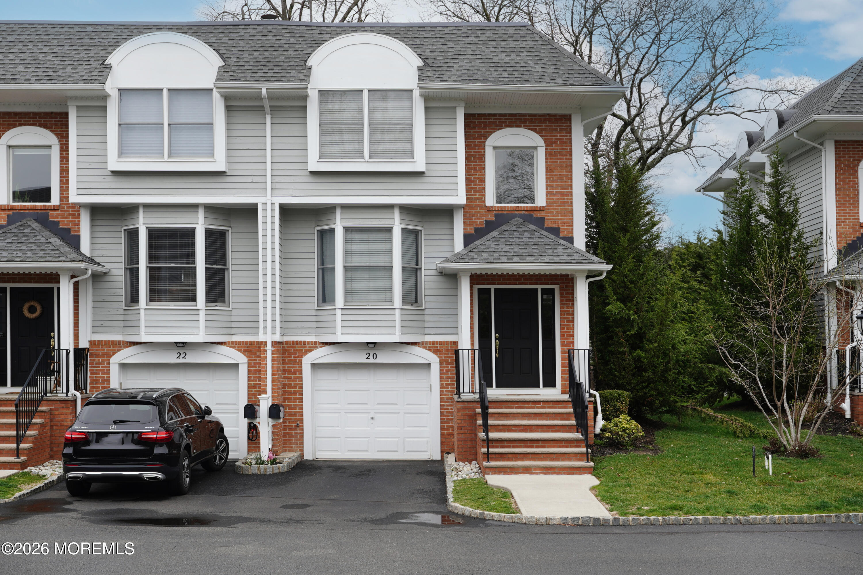 a view of a car parked in front of a brick house