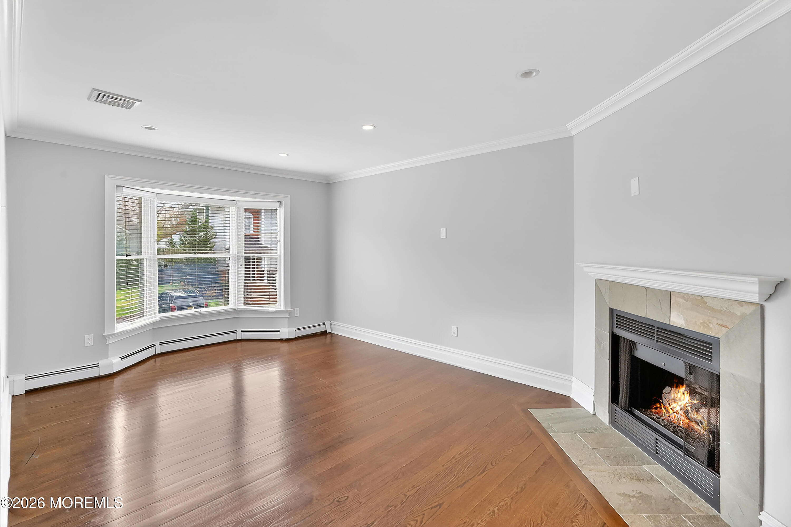 65 East River Road, Unit 20 Rumson, NJ 07760 - Photo 15 of 37 a view of an empty room with wooden floor fireplace and a window
