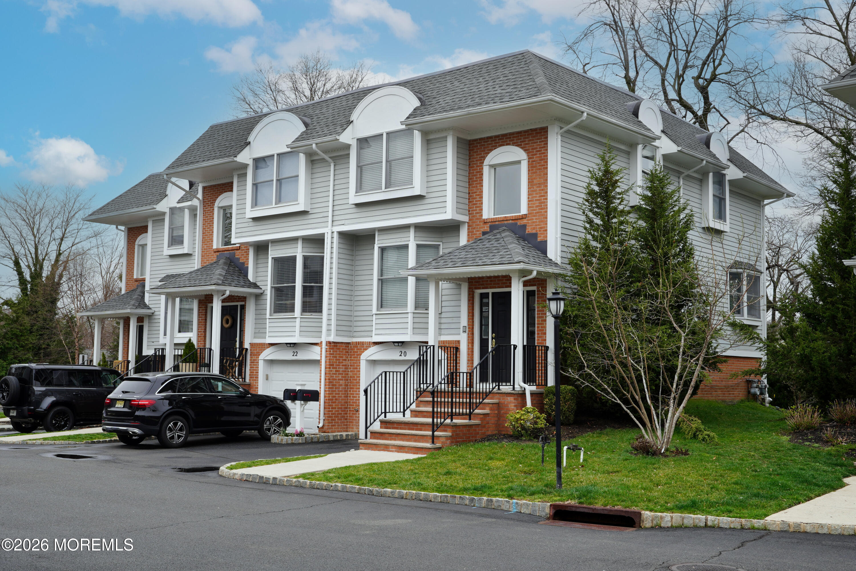 65 East River Road, Unit 20 Rumson, NJ 07760 - Photo 2 of 37 a car parked in front of a white house