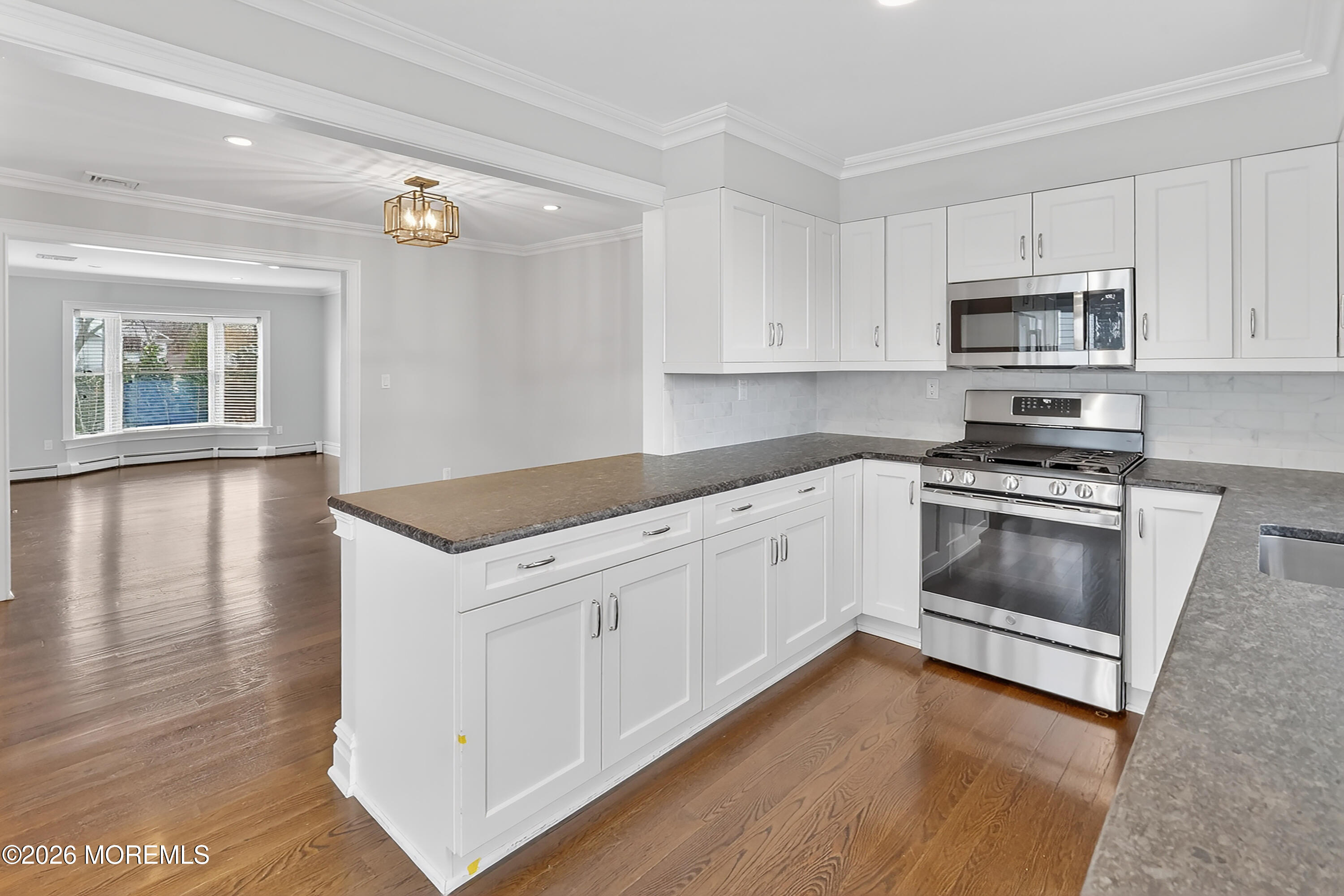 65 East River Road, Unit 20 Rumson, NJ 07760 - Photo 22 of 37 a kitchen with granite countertop white cabinets and white appliances