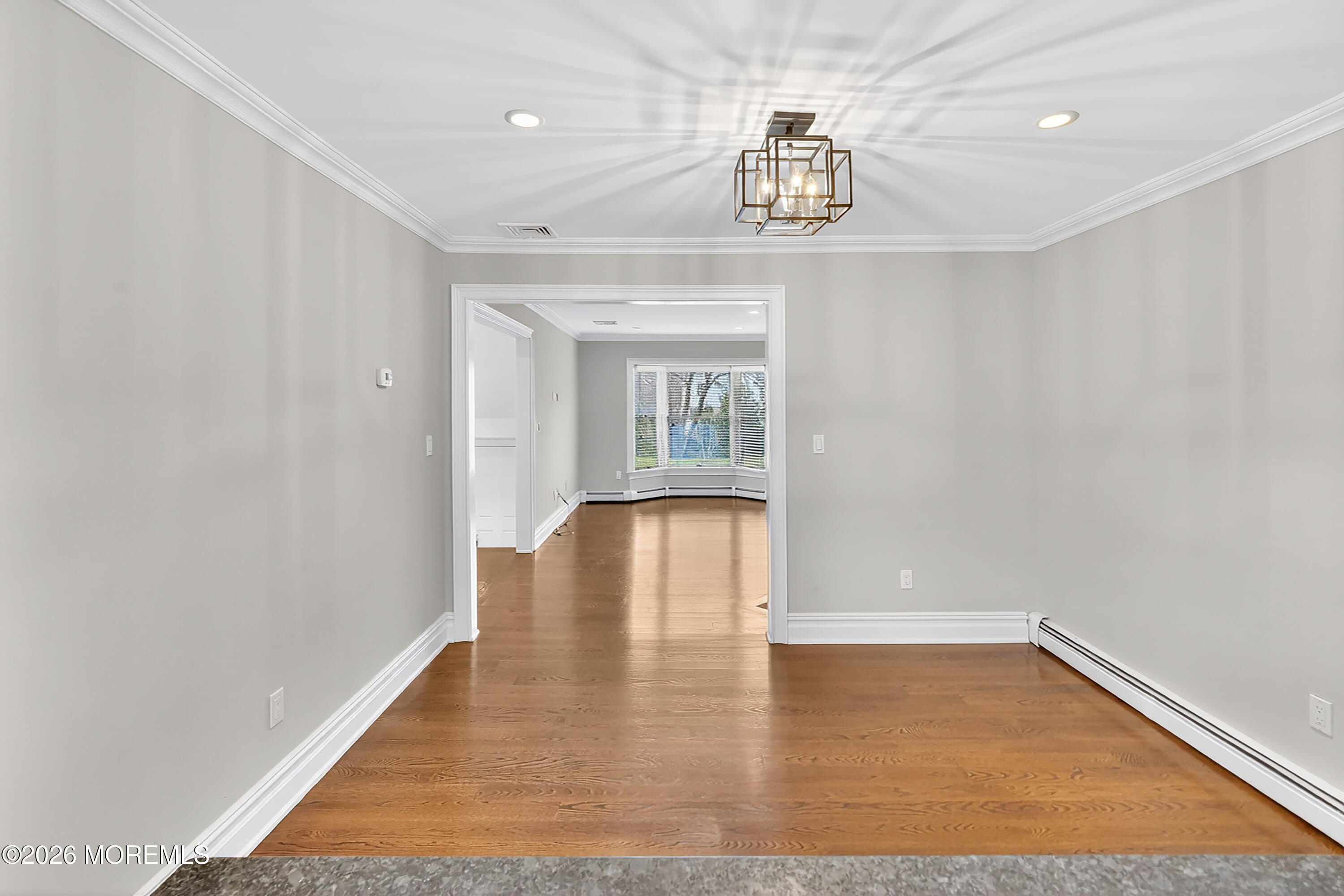 65 East River Road, Unit 20 Rumson, NJ 07760 - Photo 33 of 37 a view of empty room with wooden floor and chandelier