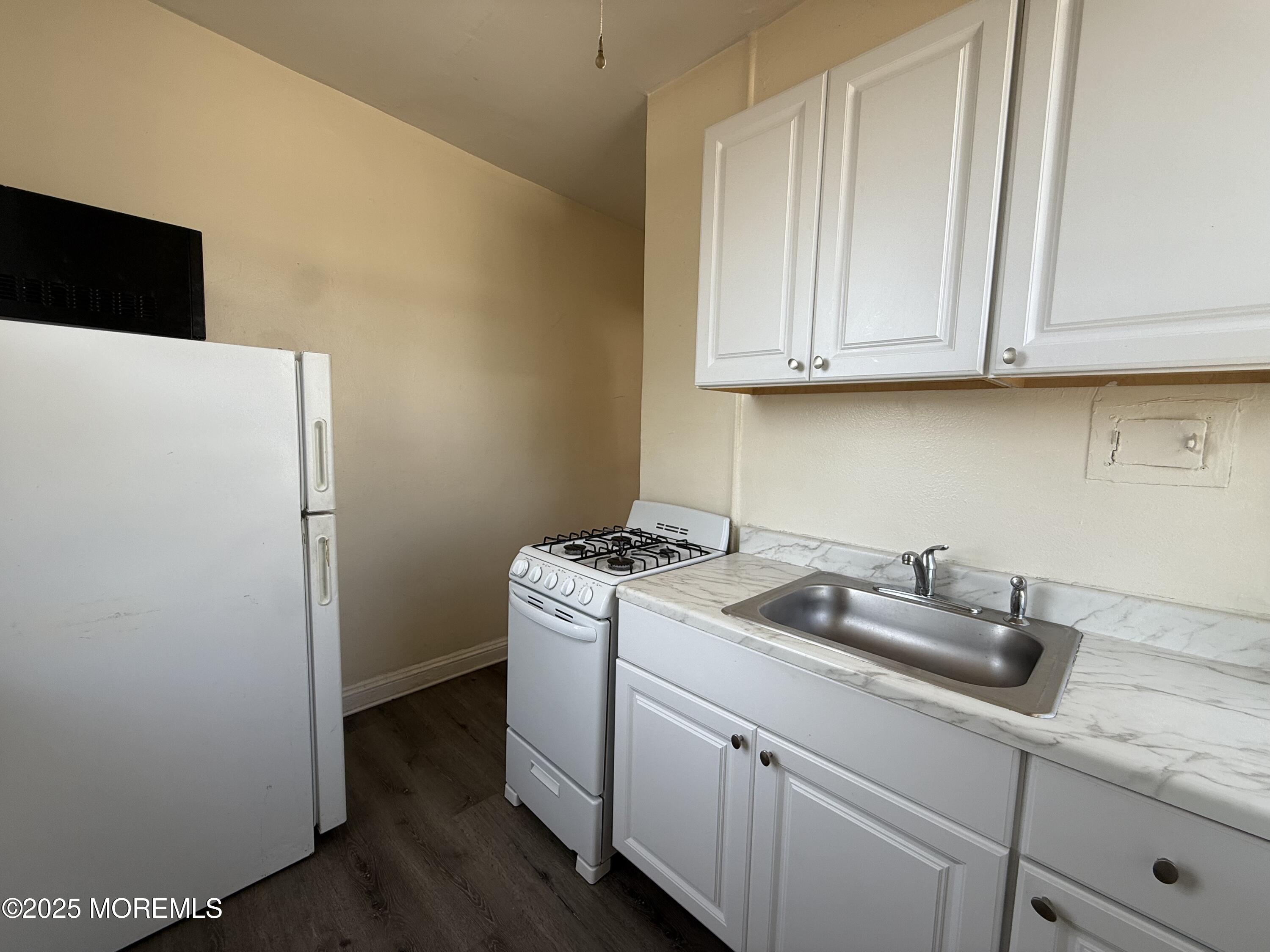 37 2nd Avenue, Unit 5 Long Branch, NJ 07740 - Photo 3 of 5 a kitchen with a sink and cabinets