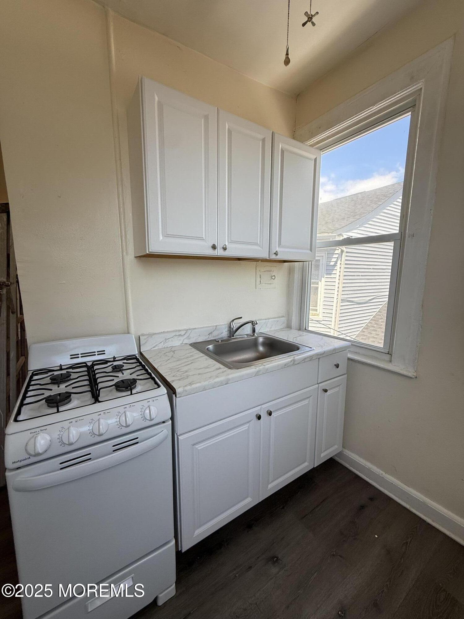 37 2nd Avenue, Unit 5 Long Branch, NJ 07740 - Photo 4 of 5 a kitchen with a sink cabinets and window