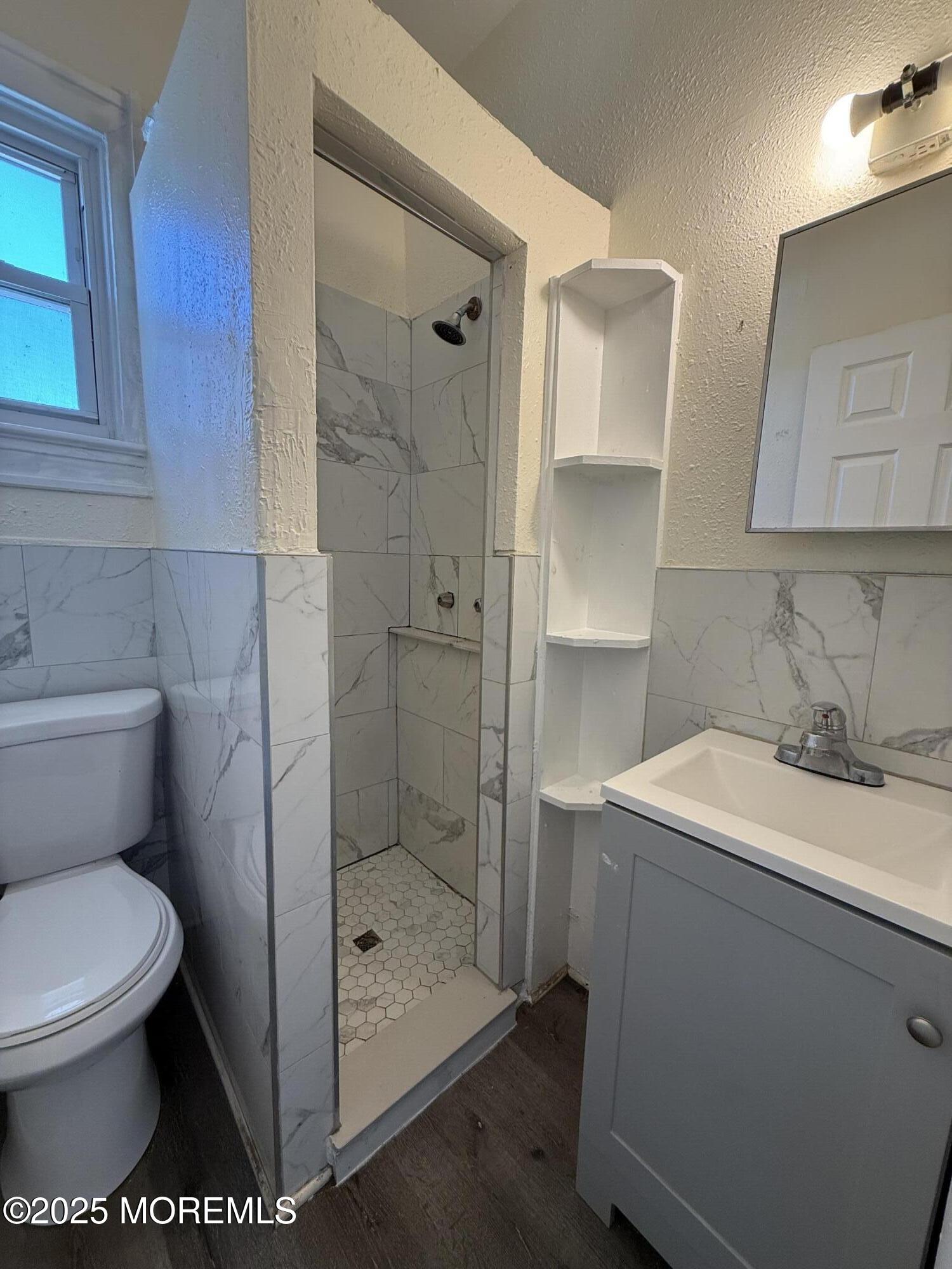 37 2nd Avenue, Unit 5 Long Branch, NJ 07740 - Photo 5 of 5 a bathroom with a toilet sink and shower