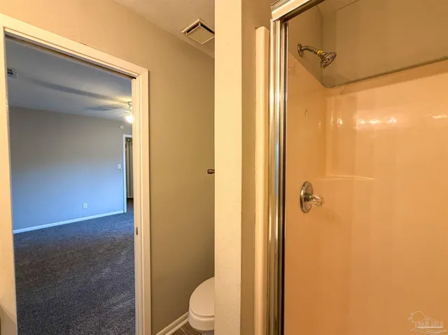 a bathroom with a toilet a sink and shower