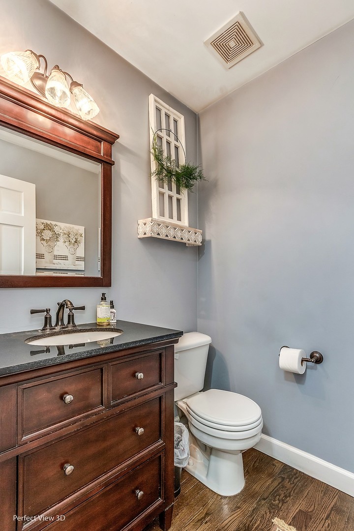 705 Churchill Lane Oswego, IL 60543 - Photo 15 of 34 a bathroom with a toilet a sink and mirror