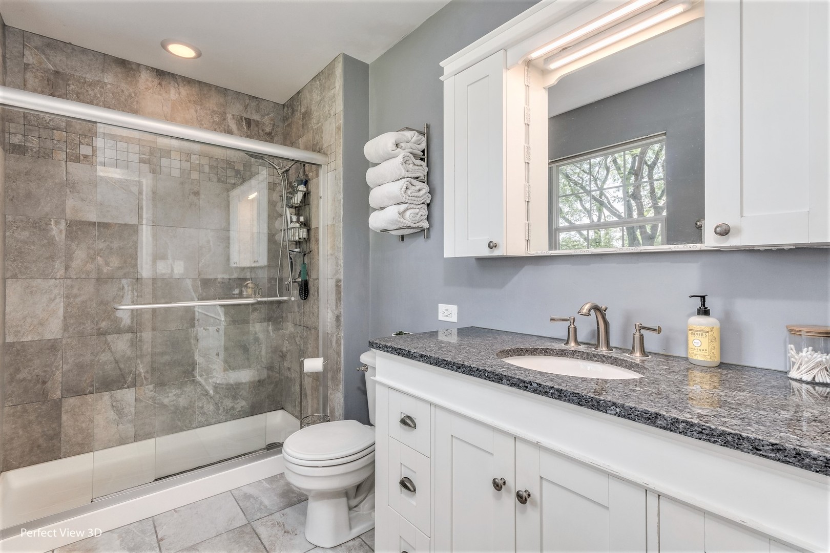 705 Churchill Lane Oswego, IL 60543 - Photo 19 of 34 a bathroom with a granite countertop sink a toilet and a shower