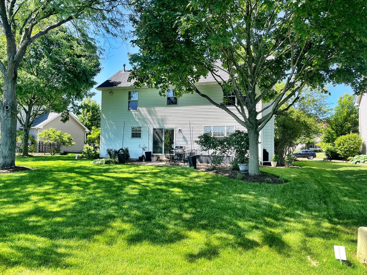 705 Churchill Lane Oswego, IL 60543 - Photo 27 of 34 a front view of house with a garden and trees