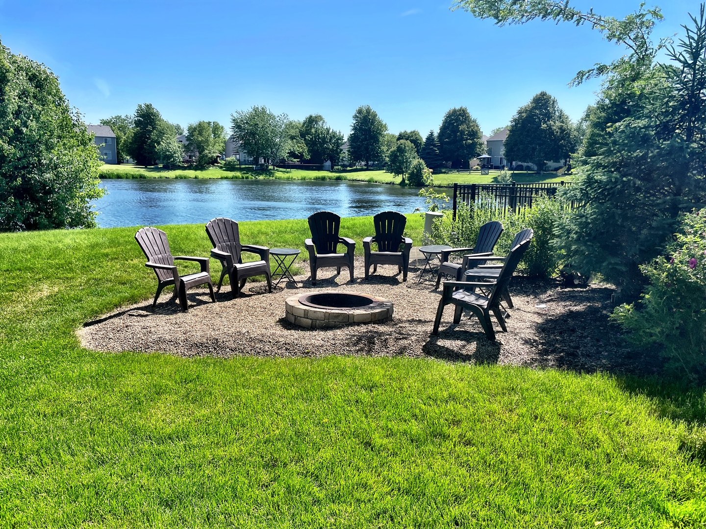 705 Churchill Lane Oswego, IL 60543 - Photo 28 of 34 a view of a lake with table and chairs