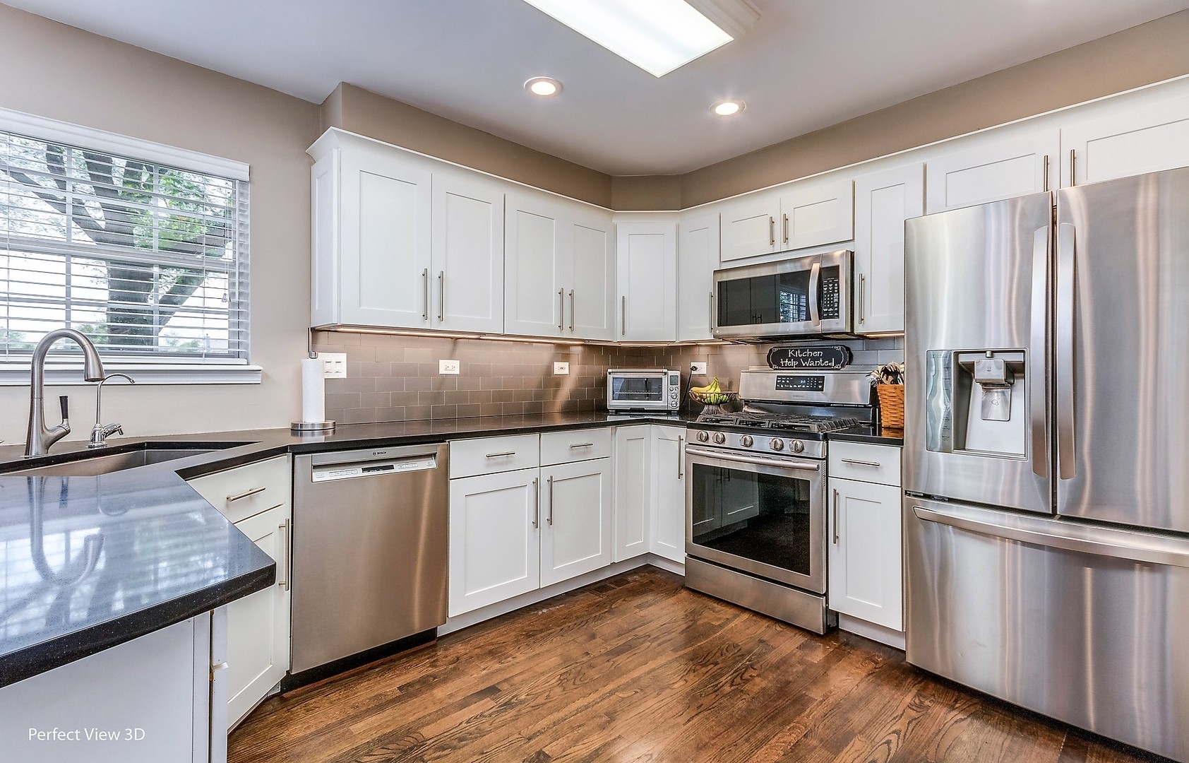705 Churchill Lane Oswego, IL 60543 - Photo 7 of 34 a kitchen with granite countertop stainless steel appliances a sink cabinets and a window