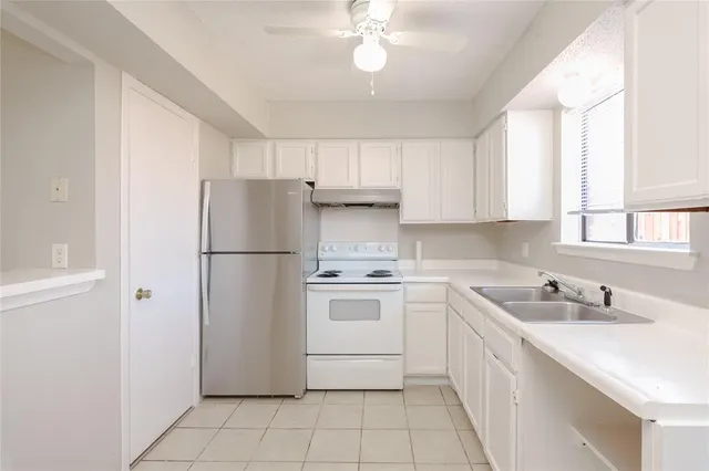 a kitchen with a white stove top oven and refrigerator