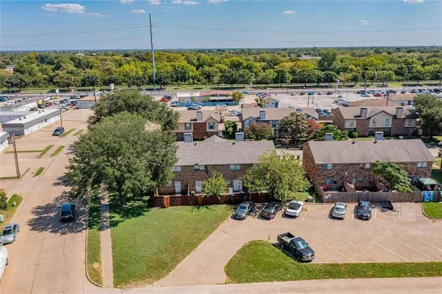 an aerial view of a house with a yard and outdoor seating