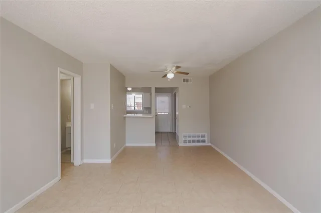 a view of a kitchen with a sink and a refrigerator