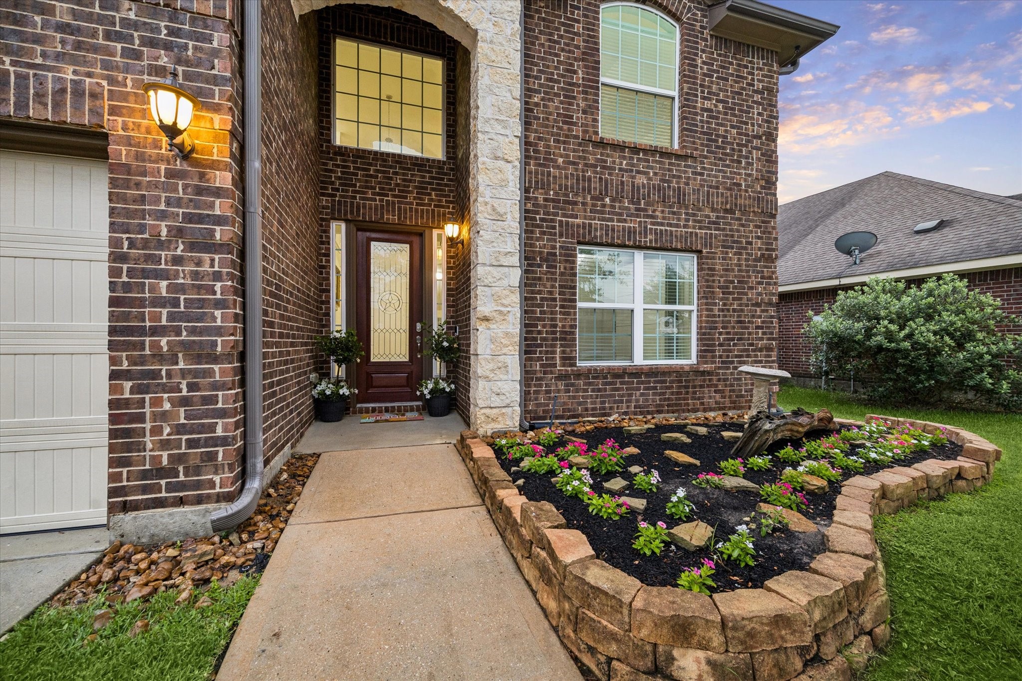 7015 Riata Hills Lane Spring, TX 77379 - Photo 1 of 33 A closer look at the inviting front entry, highlighting the rich brick façade, a beautifully designed front door, and sophisticated glass sidelights that add a refined and elegant touch.