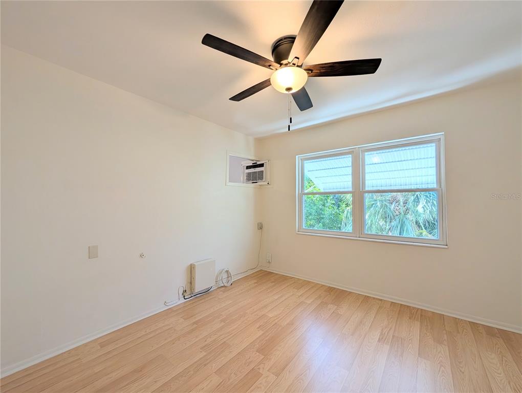 1540 Pleasant Road, Unit G35 Bradenton, FL 34207 - Photo 16 of 23 an empty room with wooden floor fan and windows