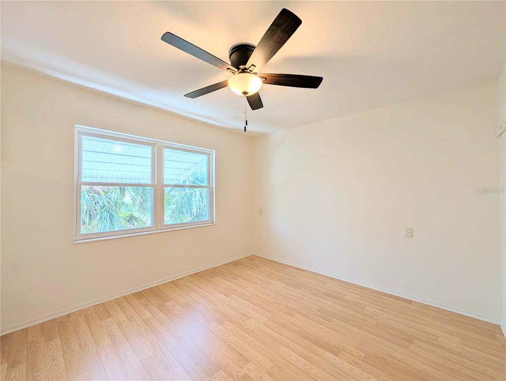1540 Pleasant Road, Unit G35 Bradenton, FL 34207 - Photo 18 of 23 wooden floor in an empty room with a window